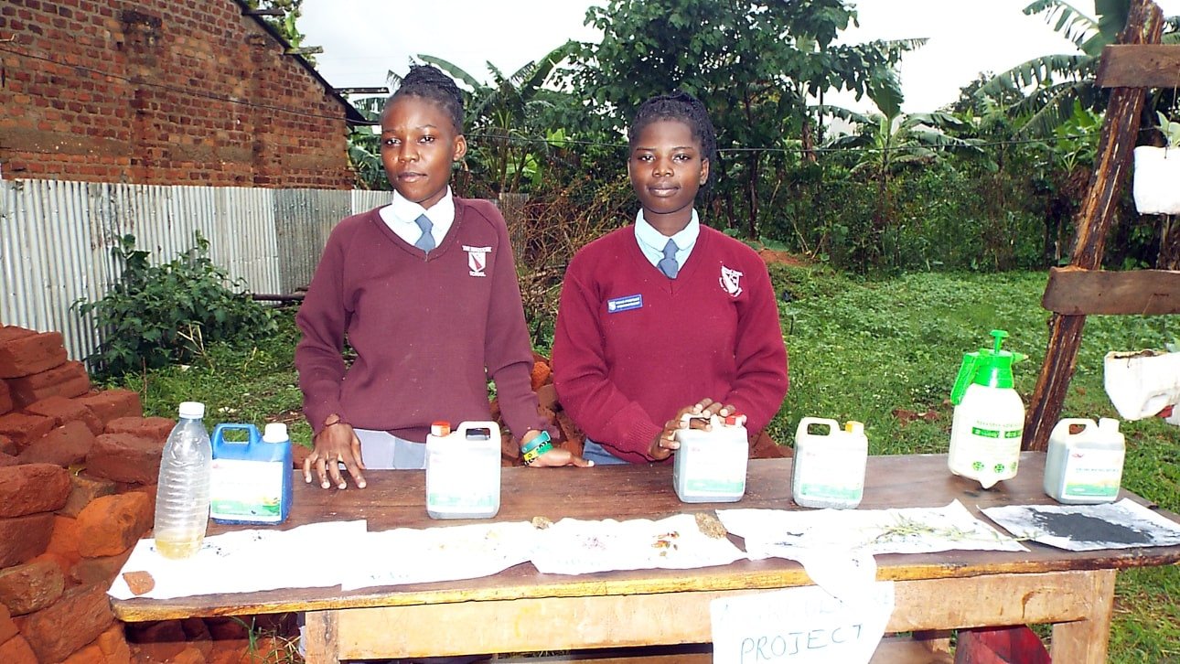 Students standing with their locally manufactured pesticide