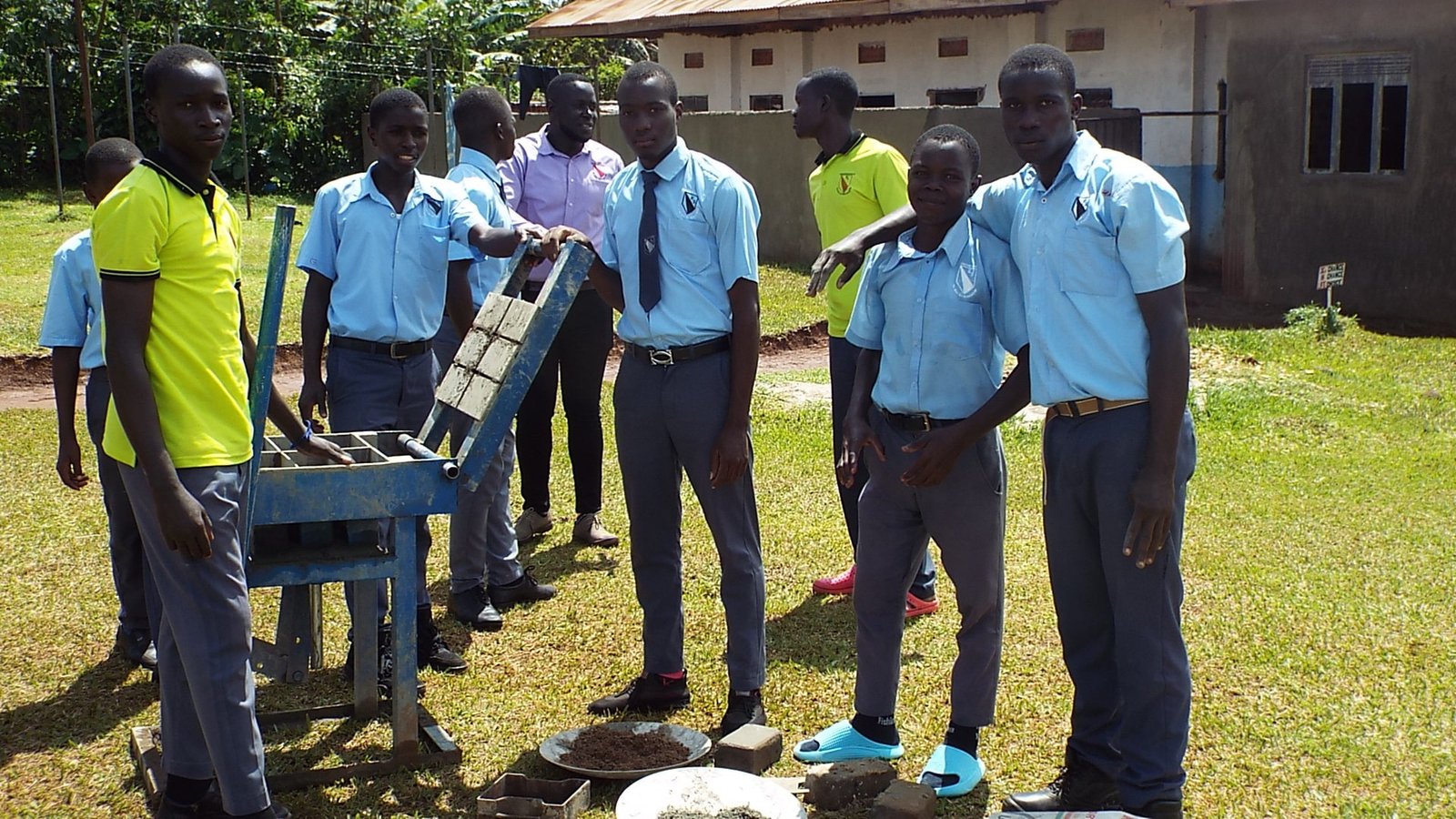 Kingstone High school students with brick making machine